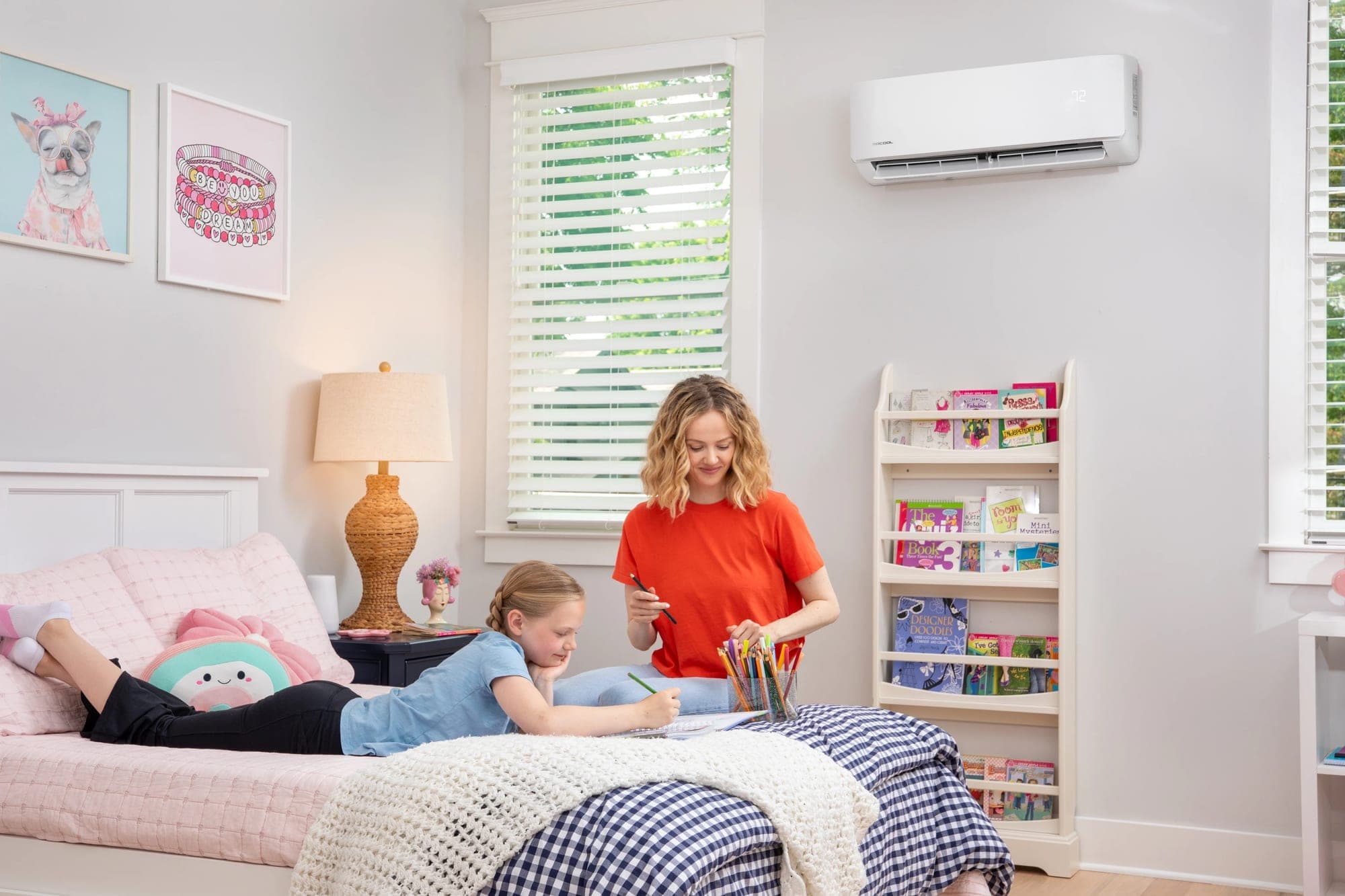 MRCOOL wall-mounted indoor unit in a furnished bedroom, with two people in the room